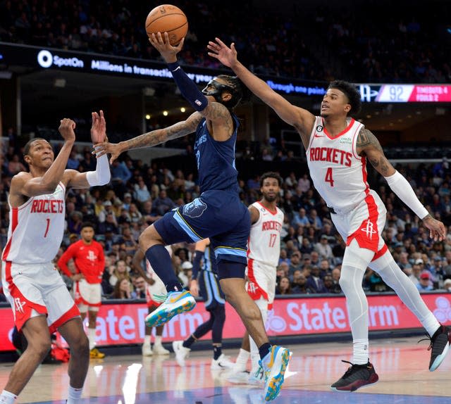 Houston Rockets players surround Memphis Grizzlies guard Ja Morant 