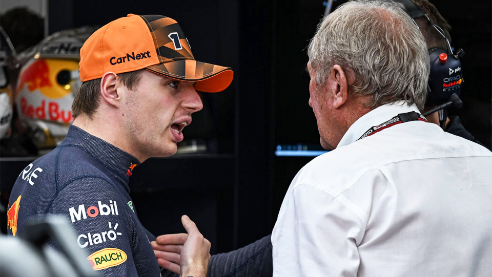 Max Verstappen (pictured left) speaking to his Red Bull team in Singapore.