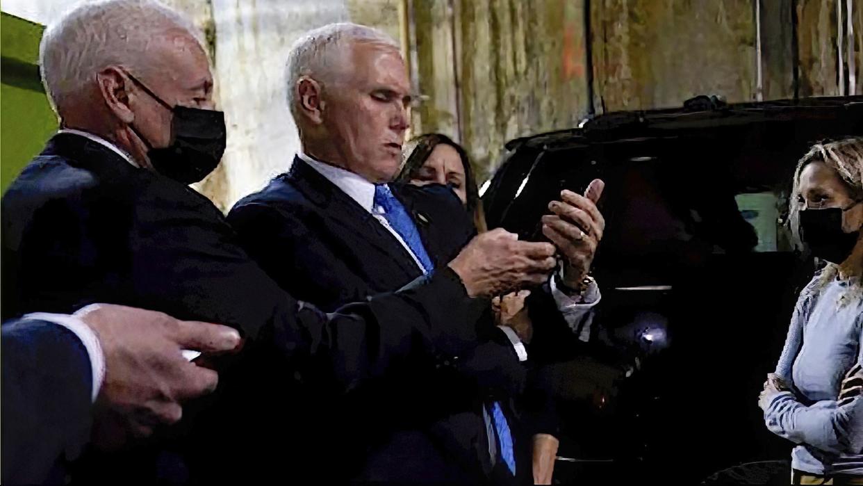 In this image from video released by the House Select Committee, Vice President Mike Pence looks at a phone from his secure evacuation location on Jan. 6.