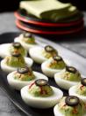 <p>Throw together these eerie eyeballs by adding thinly sliced roasted red peppers and sliced olives to deviled eggs. </p><p>Get the <strong><a href="http://www.lacocinadeleslie.com/2012/10/last-minute-halloween-recipes-deviled-eyeballs.html" rel="nofollow noopener" target="_blank" data-ylk="slk:Deviled Eyeballs recipe;elm:context_link;itc:0;sec:content-canvas" class="link ">Deviled Eyeballs recipe</a></strong> from La Cocina de Leslie. </p><p><strong>RELATED: </strong><a href="https://www.goodhousekeeping.com/food-recipes/easy/g606/deviled-eggs-recipes/" rel="nofollow noopener" target="_blank" data-ylk="slk:30+ Delicious Ways to Make Deviled Eggs;elm:context_link;itc:0;sec:content-canvas" class="link ">30+ Delicious Ways to Make Deviled Eggs</a></p>