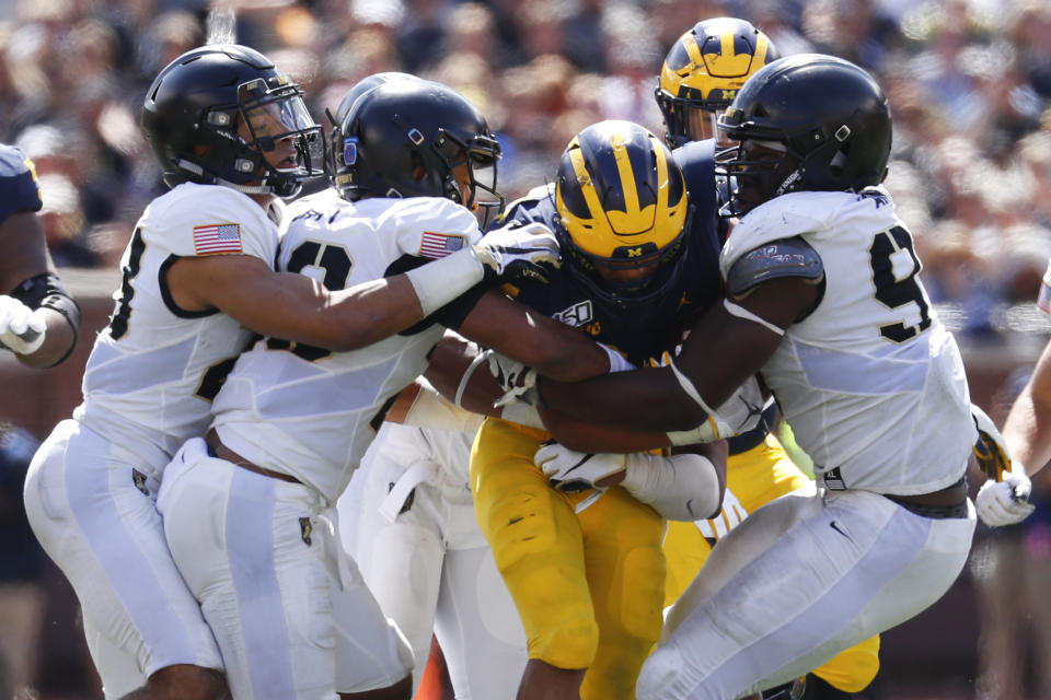 Army defenders stop Michigan running back Zach Charbonnet (24) in the second half of an NCAA college football game in Ann Arbor, Mich., Saturday, Sept. 7, 2019. Michigan won 24-21 in overtime. (AP Photo/Paul Sancya)