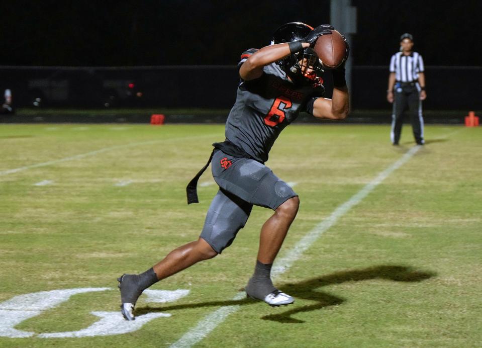 Spruce Creek's Kam Chamble (6) makes the reception and score during a game with Deltona at Spruce Creek High School in Port Orange, Friday, Sept. 1, 2023. 