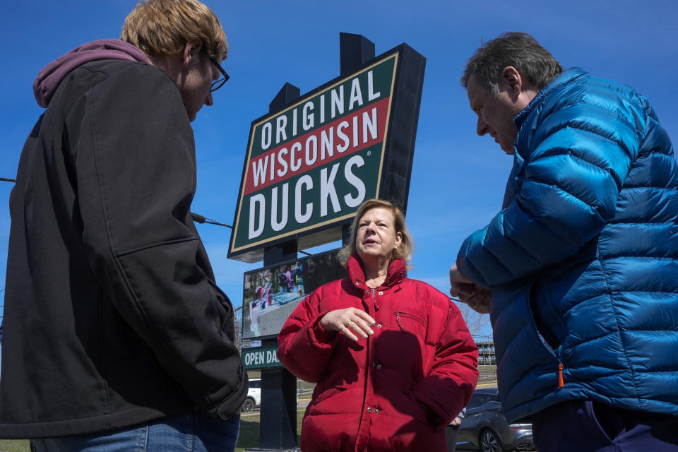 Wisconsin Democratic U.S. Sen. Tammy Baldwin talks to Dan Gavinski, right, and Chase Slack before riding a Wisconsin Dells Duck during a campaign stop Friday, March 29, 2024, in Wisconsin Dells, Wis. The stop was part of her campaign launch tour in a race against Republican Eric Hovde the could determine who has majority control of the Senate. The Wisconsin Senate race between Democratic Sen. Tammy Baldwin and Republican Eric Hovde is setting up as one of the most competitive and expensive Senate races in the country. (AP Photo/Morry Gash)