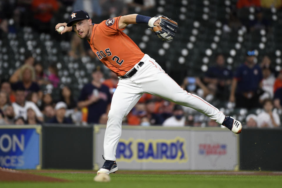 Houston Astros third baseman Alex Bregman throws out Oakland Athletics' Ramon Laureano during the first inning of a baseball game, Friday, April 9, 2021, in Houston. (AP Photo/Eric Christian Smith)