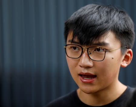 Isaac Cheng, vice-chairperson of Demosisto, a pro-democracy party in Hong Kong, speaks to the members of the media after the arrest of the pro-democracy activist Joshua Wong, in Hong Kong