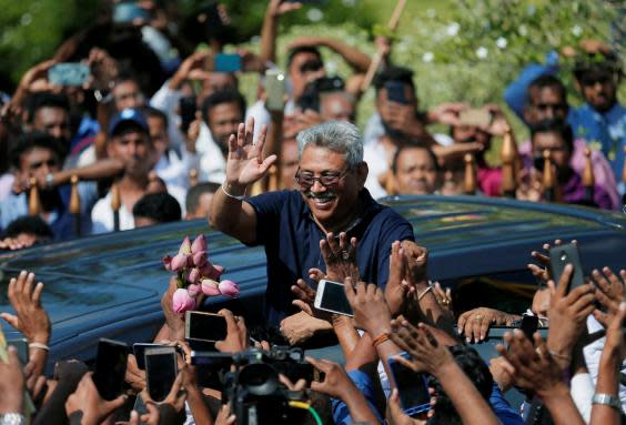 Former defence secretary Gotabaya Rajapaksa greets fans in April after returning from the US (Reuters)