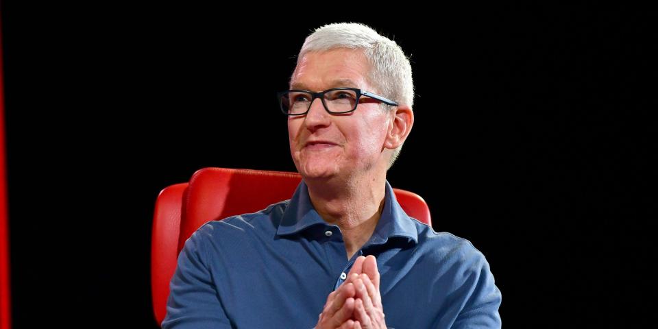 Tim Cook Apple sitting on a red chair