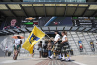 Indianapolis 500 Gordon Pipers member Ayrton Hardwick carries an Indiana Pacers flag before qualifications for the Indianapolis 500 auto race at Indianapolis Motor Speedway, Sunday, May 19, 2024, in Indianapolis. The Pacers play the New York Knicks in game seven of the NBA basketball second-round playoff series. (AP Photo/Darron Cummings)