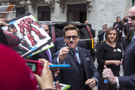 Actors Robert Downey Jr. signs autographs as he arrives to promote the film Avengers: Age of Ultron at the New York Stock Exchange April 27, 2015. REUTERS/Lucas Jackson