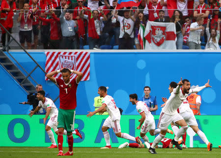 Soccer Football - World Cup - Group B - Morocco vs Iran - Saint Petersburg Stadium, Saint Petersburg, Russia - June 15, 2018 Iran players celebrate after Morocco's Aziz Bouhaddouz scores an own goal and the first for Iran REUTERS/Michael Dalder