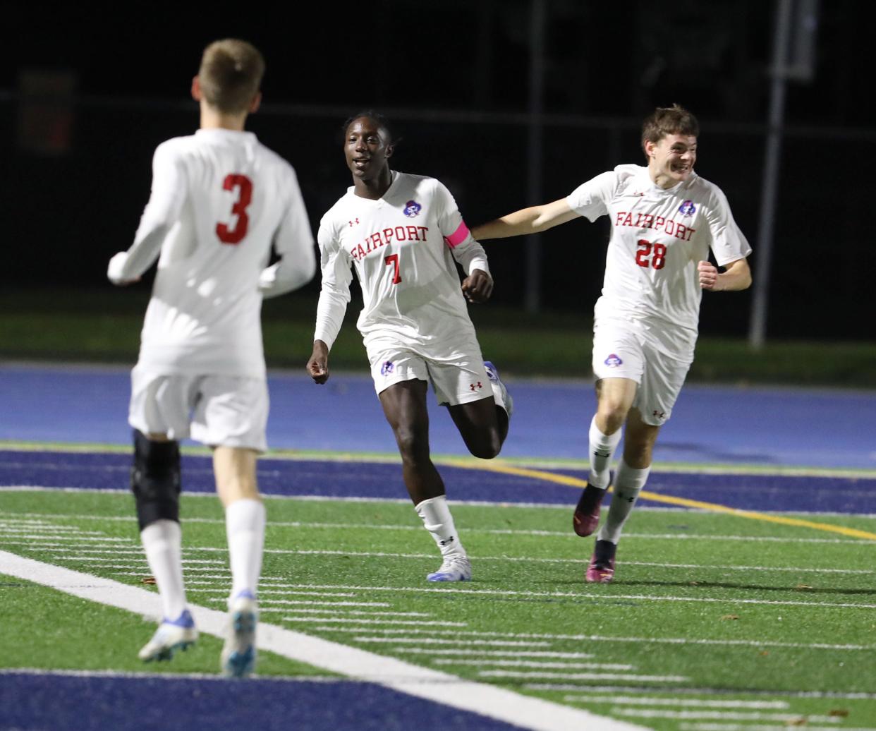 Fairport's Myles Palmer celebrates the first of his two goals with teammate Paul Murgoci during their soccer match at Brighton High School in Brighton, NY on Oct. 3, 2022.  