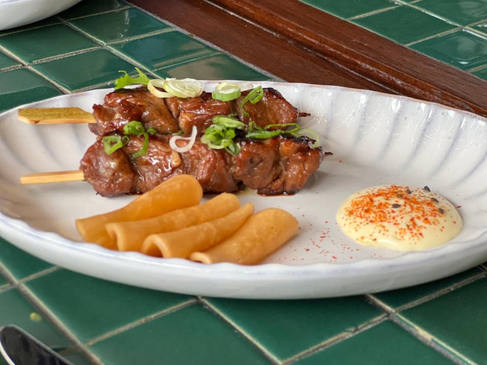 Pyro's Iberico pork skewers are marinated in a housemade tare sauce and roasted on the charcoal yakitori.