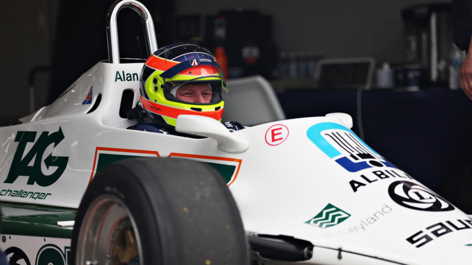 Zak Brown, CEO of McLaren Racing, sits behind the wheel of his Williams FW07 before a parade of historic Formula 1 cars at the UK's Silverstone track last year.