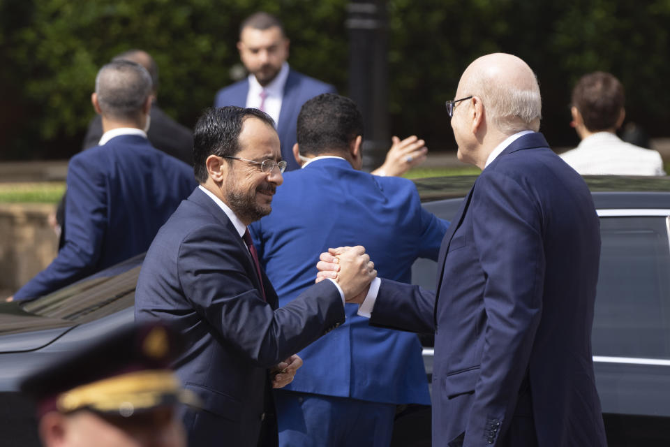 Lebanese caretaker Prime Minister Najib Mikati, right, welcomes Cyprus' president Nikos Christodoulides before their meeting at the government palace in Beirut, Lebanon, Thursday, May 2, 2024. (AP Photo/Hassan Ammar)