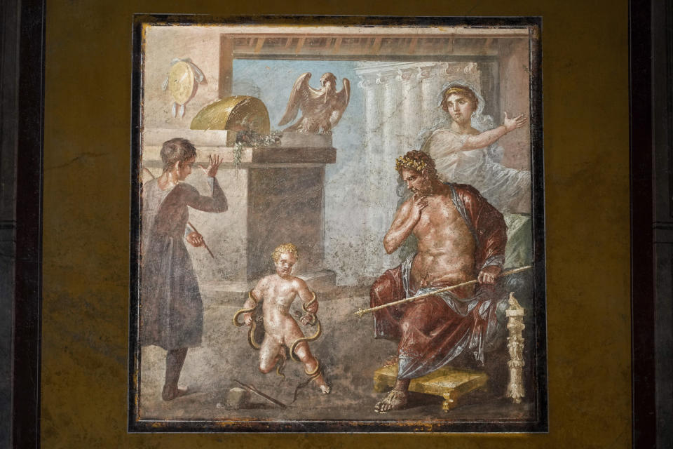 A view of a fresco depicting Hercules as a child choking snakes that adorns the "triclinium", or dining room, called Hall of Pentheus, part of the Ancient Roman Domus Vettiorum, House of Vettii, in the Pompeii Archeological Park, near Naples, southern Italy, Wednesday, Dec. 14, 2022. One of Pompeii's most famous and richest domus, which contains exceptional works of art and tells the story of the social ascent of two former slaves, is opening its doors to visitors Wednesday, Jan. 11, 2023 after 20 years of restoration. (AP Photo/Andrew Medichini)