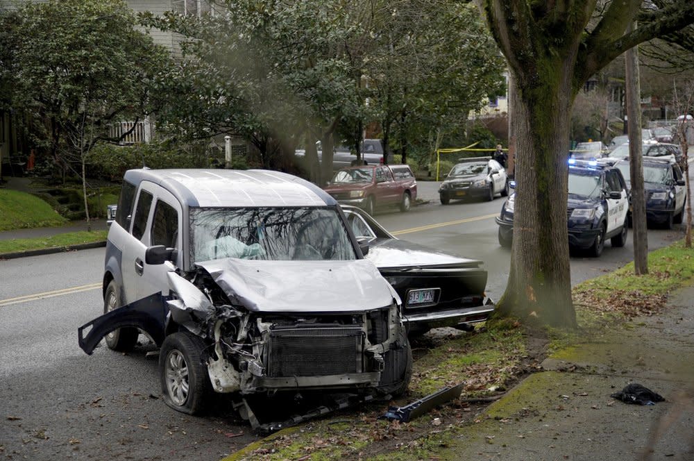A wrecked vehicle is seen after a driver struck and injured at least five people over a 20-block stretch of Southeast Portland, Ore., before crashing and fleeing on Monday, Jan. 25, 2021, according to witnesses. (Beth Nakamura/The Oregonian via AP)