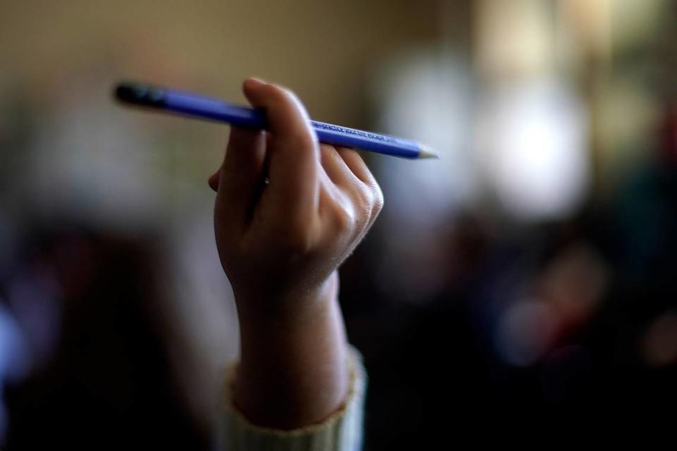 A student raises her hand to ask a question in her third grade classroom at Highland Elementary School in Columbus, Kansas, in October. Across the country, federal data show, the disruptions wrought by the pandemic were accompanied by widespread learning setbacks, even in states that saw students return quickly to in-person learning. Among those showing the largest learning losses are this year’s crop of third graders, who were in kindergarten when the pandemic hit, a foundational year for learning to read.