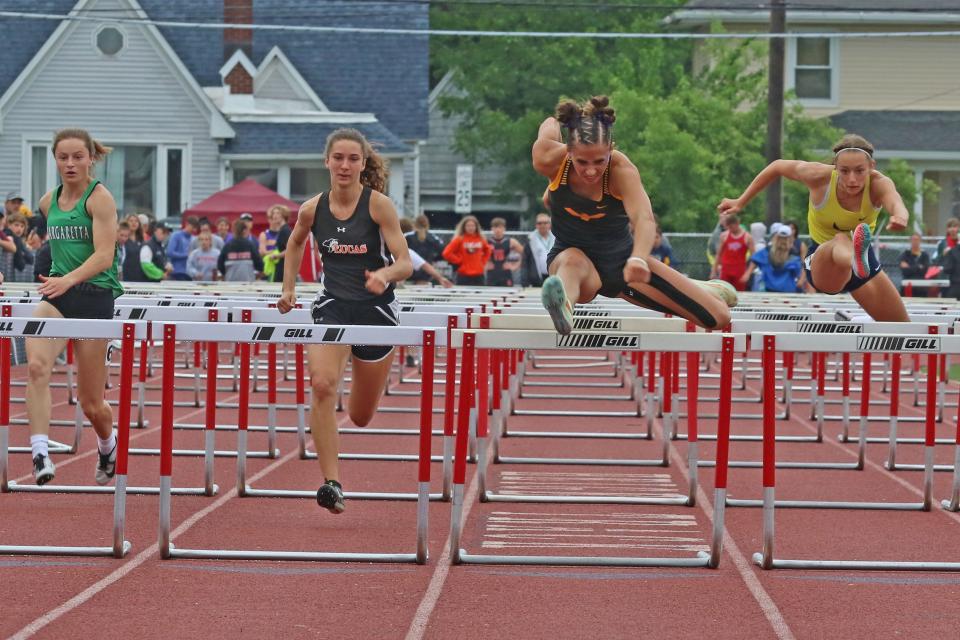 Lucas's Shelby Grover and Colonel Crawford's Katie Ruffener run the 100 hurdles.