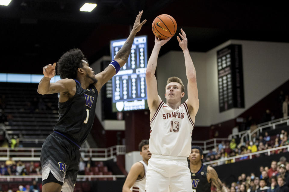 Stanford guard Michael Jones (13) shoots over Washington forward Keion Brooks (1) during the first half of an NCAA college basketball game in Stanford, Calif., Sunday, Feb. 26, 2023. (AP Photo/John Hefti)