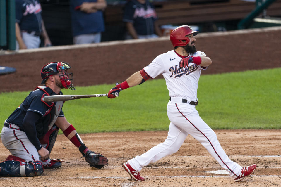 CORRECTS TO TWO-RUN HOME RUN, INSTEAD OF SOLO HOME RUN - Washington Nationals' Adam Eaton follows the ball next to Atlanta Braves catcher Tyler Flowers as he hits a two-run home run during the second inning of a baseball game in Washington, Thursday, Sept. 10, 2020. (AP Photo/Manuel Balce Ceneta)