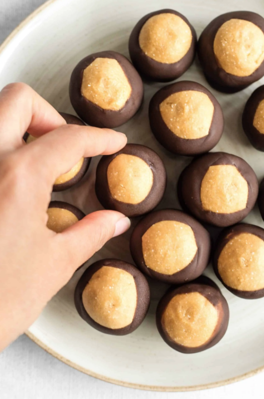 <p>Dish by Dish</p><p>These peanut butter buckeye balls are the perfect bite-sized treat: creamy peanut butter fudge coated with chocolate. Gluten-free and vegan.</p><p><strong>Get the recipe: <a href="https://www.dishbydish.net/peanut-butter-buckeye-balls/" rel="nofollow noopener" target="_blank" data-ylk="slk:Peanut Butter Buckeye Balls;elm:context_link;itc:0;sec:content-canvas" class="link rapid-noclick-resp">Peanut Butter Buckeye Balls</a></strong></p>
