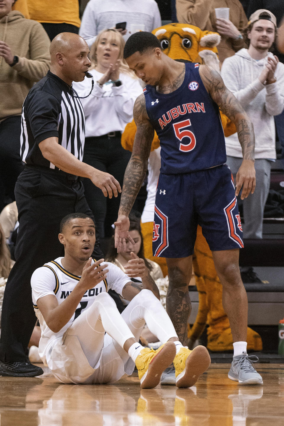 Missouri's Xavier Pinson, left, reacts after getting called for a foul on Auburn's J'Von McCormick, right, during the first half of an NCAA college basketball game Saturday, Feb. 15, 2020, in Columbia, Mo. (AP Photo/L.G. Patterson)