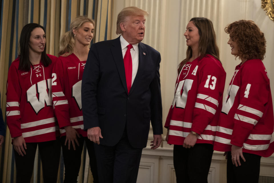 President Donald Trump talks with members of the University of Wisconsin-Madison Women's Hockey Team during the NCAA Collegiate National Champions Day at the White House, Friday, Nov. 22, 2019, in Washington. (AP Photo/ Evan Vucci)