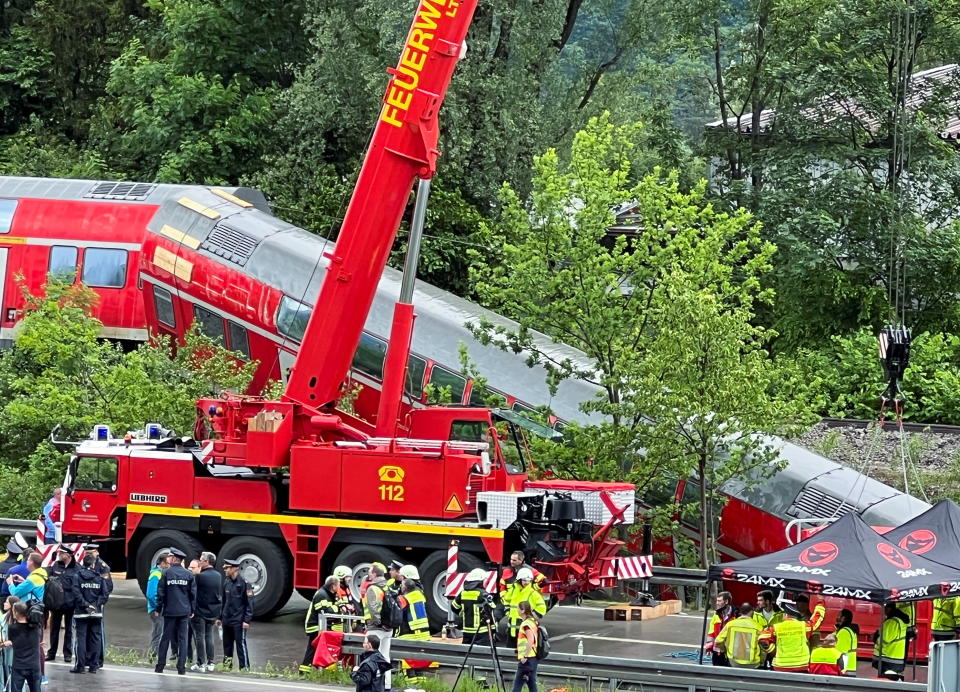 Firefighters use heavy equipment to search for victims of a derailed double-decker DB regional train near the Bavarian town of Garmisch-Partenkirchen, Germany, June 3, 2022. At least four people were killed and around a dozen others are still missing police and local officials said. Vifogra/Michael Schmelzer via REUTERS THIS IMAGE HAS BEEN PROVIDED BY A THIRD PARTY. MANDATORY CREDIT