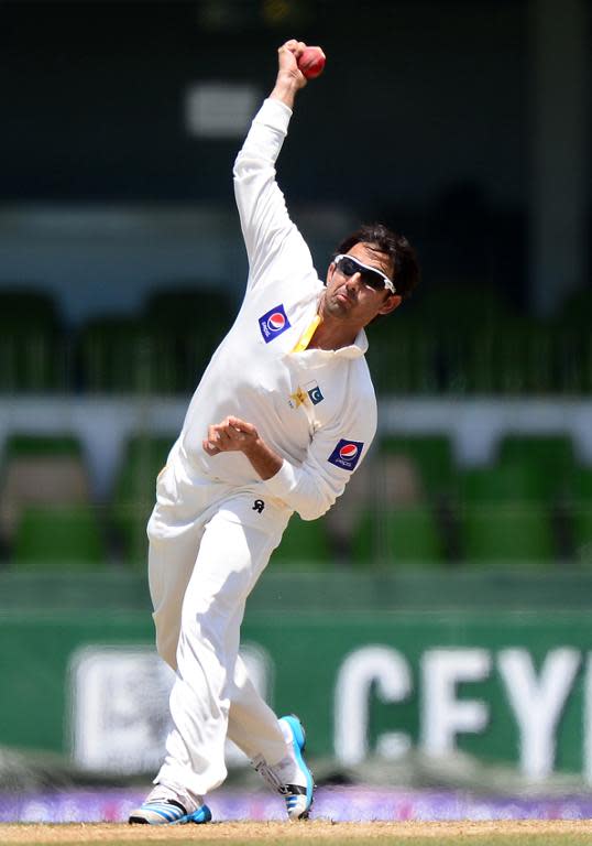 File photo taken on August 14, 2014 shows Pakistan spinner Saeed Ajmal delivering a ball during the second Test against Sri Lanka in Colombo