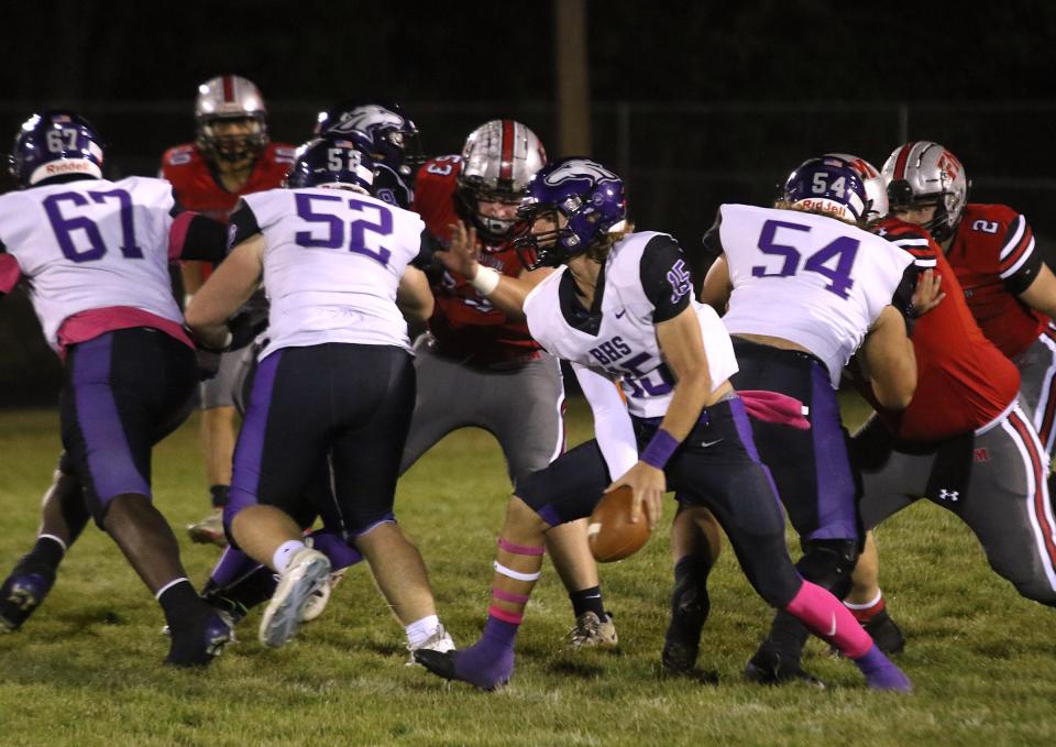 Burlington’s Gabe Robinson (15) pitches to a running back during the game against Fort Madison Friday in Fort Madison.