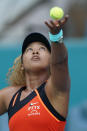 Naomi Osaka, of Japan, serves to Alison Riske during the Miami Open tennis tournament, Monday, March 28, 2022, in Miami Gardens, Fla. (AP Photo/Wilfredo Lee)