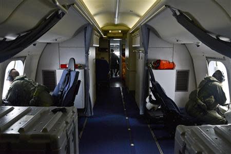 Naval aircrewmen assigned to Patrol Squadron (VP) 16 look for floating debris while on a P-8A Poseidon during search and rescue operations for Malaysia Airlines flight MH370 in this March 24, 2014 handout photo. REUTERS/Mass Communication Specialist 2nd Class Eric A. Pastor/U.S. Navy/Handout via Reuters