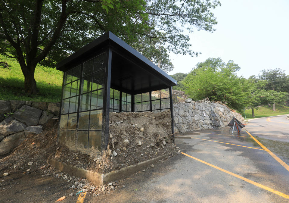 A bust stop is packed with dirt beside a washed out hill at West Point on July 17, 2023. A severe rain storm on July 9 caused an estimated $100 million in damages around West Point.