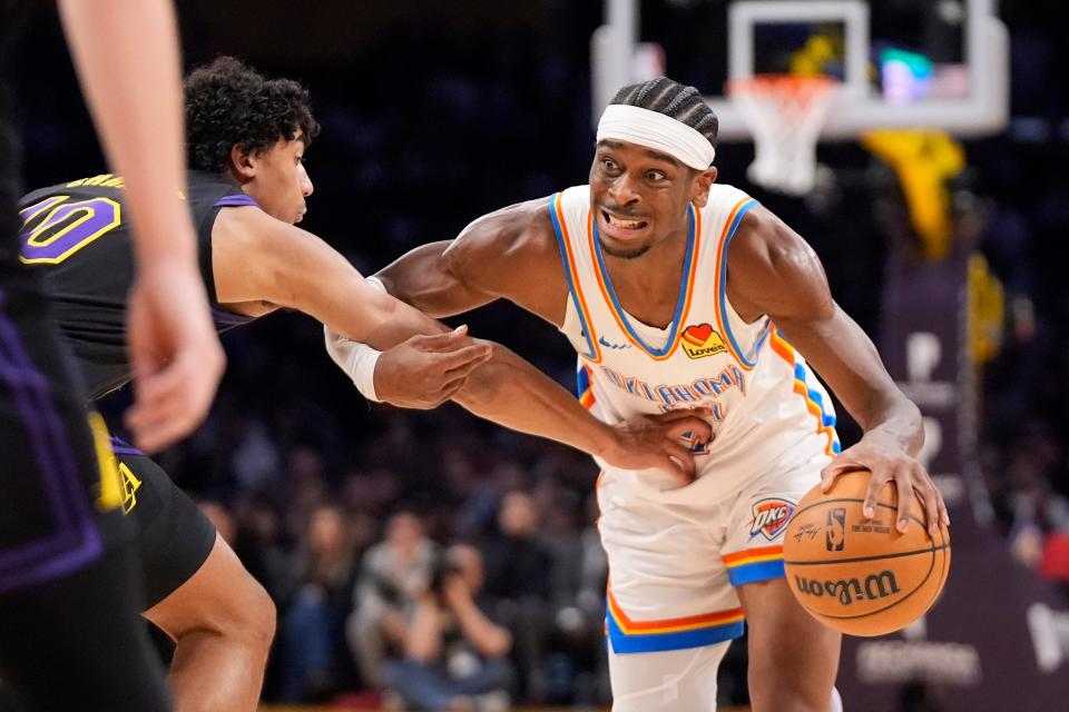 Oklahoma City Thunder guard Shai Gilgeous-Alexander, right, tries to drive by Los Angeles Lakers guard Max Christie during the first half of an NBA basketball game Monday, Jan. 15, 2024, in Los Angeles. (AP Photo/Mark J. Terrill)