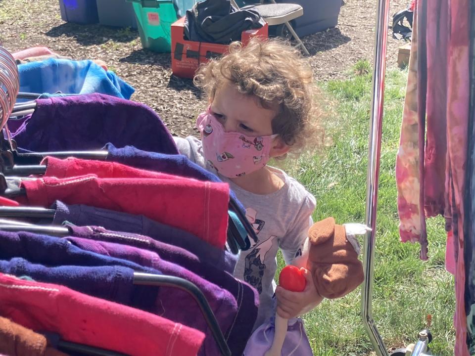 Lucy Crowley, 3, of Springfield, looks at some tie dye shirts at the Edwards Place Fine Art Fair on Sept. 19, 2020. Lucy came to the art show with her parents, Jake and Rebecca Crowley, her brother, Elijah, 8, and sister, Viola, 6. This year's fair runs Sept. 16-17.