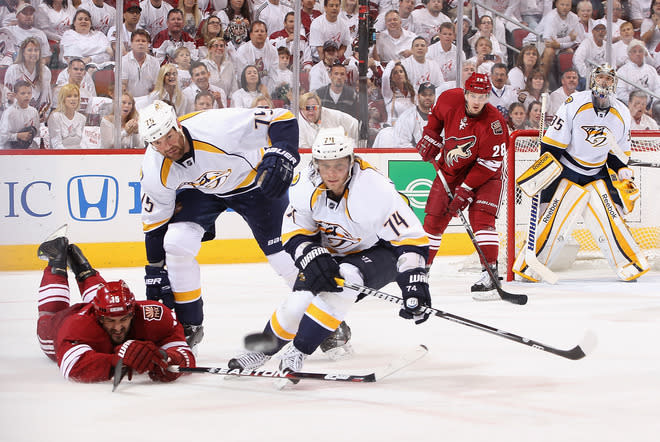 GLENDALE, AZ - APRIL 27: Sergei Kostitsyn #74 and Hal Gill #75 of the Nashville Predators clear the puck away from Boyd Gordon #15 of the Phoenix Coyotes in the second period of Game One of the Western Conference Semifinals during the 2012 NHL Stanley Cup Playoffs at Jobing.com Arena on April 27, 2012 in Glendale, Arizona. (Photo by Christian Petersen/Getty Images)