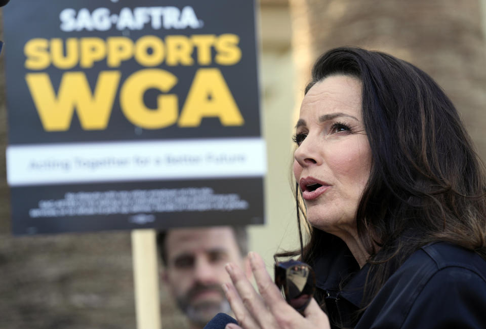 FILE - Fran Drescher, president of SAG-AFTRA, is interviewed at a Writers Guild of America rally outside Paramount Pictures studio on May 8, 2023, in Los Angeles. In the ’90s, Drescher rose to fame as the co-creator and star of “The Nanny.” She is now the first president of the guild to preside over a film and TV actors strike since 1980. Actors have been on strike since July and, like the screenwriters who began picketing earlier this year, they're seeking better pay in an industry vastly changed due to streaming and the emergence of artificial intelligence. (AP Photo/Chris Pizzello, File)