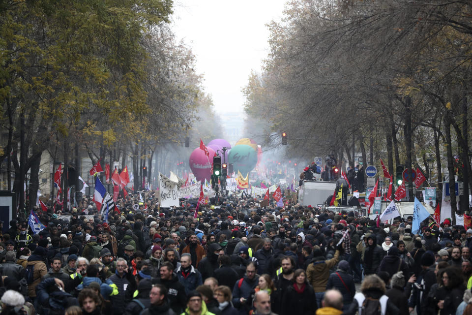 People march during a demonstration in Paris, Thursday, Dec. 5, 2019. The Eiffel Tower shut down, France's vaunted high-speed trains stood still and several thousand protesters marched through Paris as unions launched open-ended, nationwide strikes Thursday over the government's plan to overhaul the retirement system. (AP Photo/Thibault Camus)