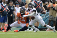 Denver Broncos wide receiver Courtland Sutton (14) catches a pass despite defensive effort by Jacksonville Jaguars cornerback Chris Claybrooks, right, during the first half of an NFL football game, Sunday, Sept. 19, 2021, in Jacksonville, Fla. (AP Photo/Phelan M. Ebenhack)