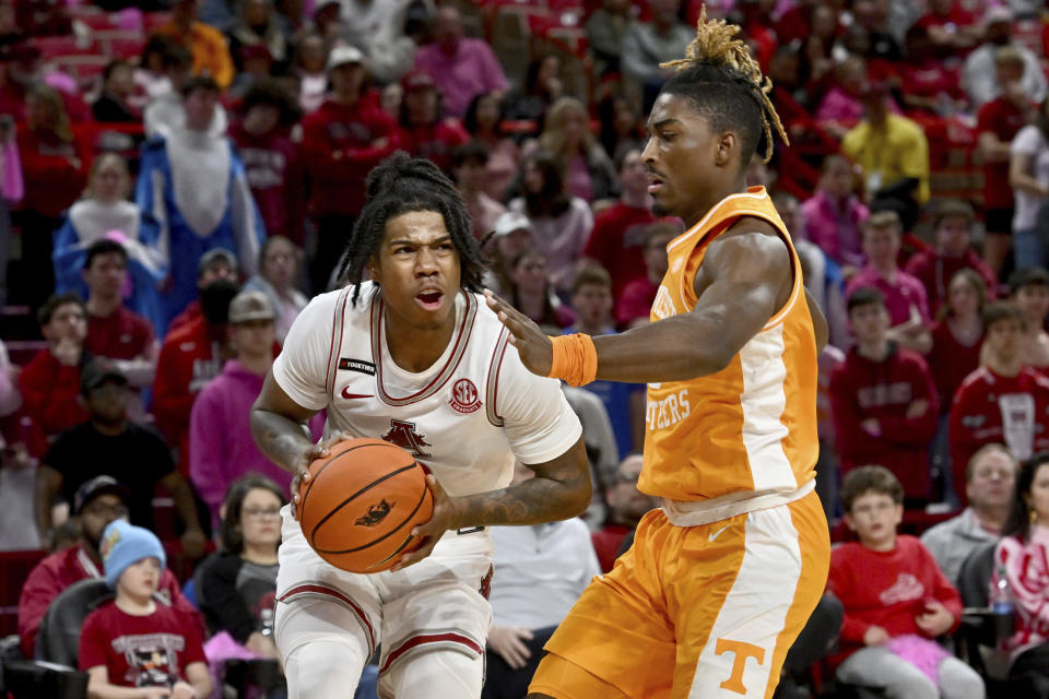 Arkansas guard Khalif Battle (0) tries to get past Tennessee guard Jahmai Mashack during the second half of an NCAA college basketball game Wednesday, Feb. 14, 2024, in Fayetteville, Ark. (AP Photo/Michael Woods)