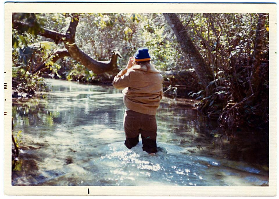 A family snapshot shows someone walking down a spring run, an activity we know today can damage underwater ecosystems.