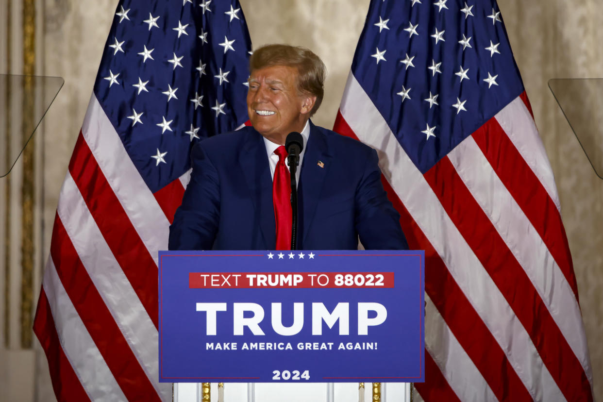 Donald Trump stands at a podium labeled: Trump, make American great again! 2024