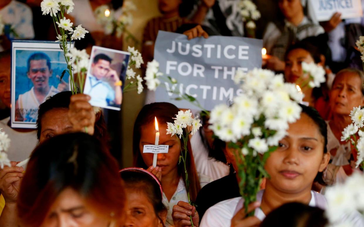 Relatives of victims of the Philippines war on drugs hold a memorial for their loved ones - AP