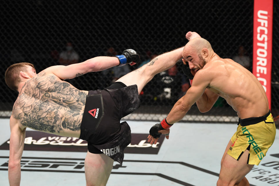 ABU DHABI, UNITED ARAB EMIRATES - OCTOBER 11:  (L-R) Cory Sandhagen kicks Marlon Moraes of Brazil in their bantamweight bout during the UFC Fight Night event inside Flash Forum on UFC Fight Island on October 11, 2020 in Abu Dhabi, United Arab Emirates. (Photo by Josh Hedges/Zuffa LLC via Getty Images)