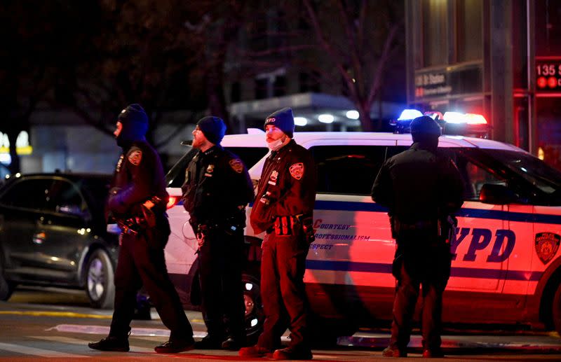 Emergency personnel respond at the scene where NYPD officers were shot while responding to a domestic violence call