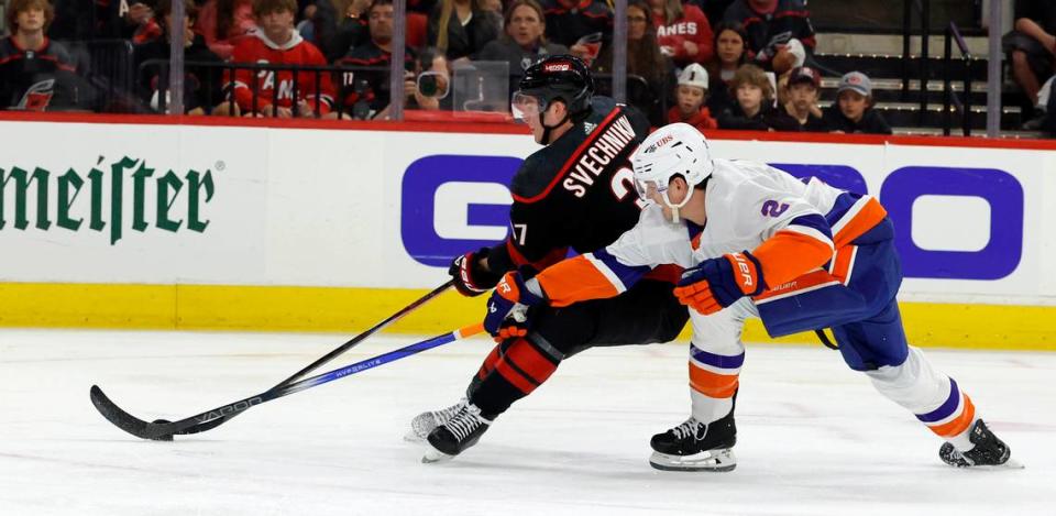 Carolina right wing Andrei Svechnikov (37) battles for the puck with New York defenseman Mike Reilly (2) during the first period of the Hurricanes game against the Islanders in the first round of the Stanley Cup playoffs at PNC Arena in Raleigh, N.C., Saturday, April 20, 2024.