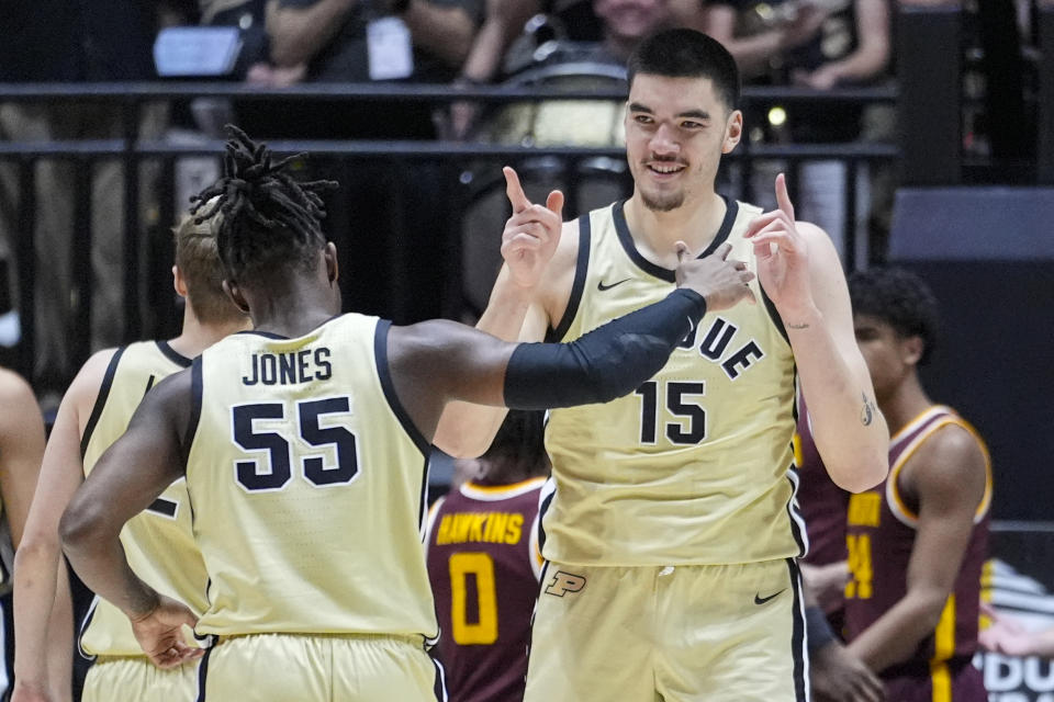 Purdue center Zach Edey (15) celebrates being fouled on a basket with guard Lance Jones (55) during the first half of an NCAA college basketball game against Minnesota in West Lafayette, Ind., Thursday, Feb. 15, 2024. (AP Photo/Michael Conroy)