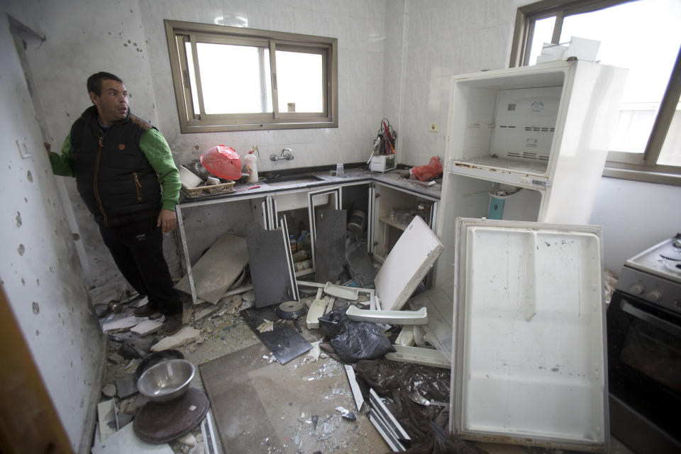 A Palestinian looks at a damage after an Israeli raid killed Ashraf Naalweh during an arrest raid in the Asker refugee camp near the West Bank city of Nablus, Thursday, Dec. 13, 2018. Israel accuses Naalweh of shooting to death two Israelis and wounding another at an attack on a West Bank industrial zone in October. He fled the scene and Israeli forces have been searching for him since. (AP Photo/Majdi Mohammed)