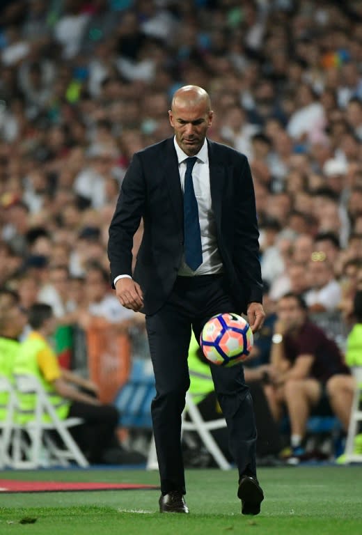 Real Madrid's French coach Zinedine Zidane kicks the ball during the match against Celta de Vigo at the Santiago Bernabeu stadium in Madrid on August 27, 2016