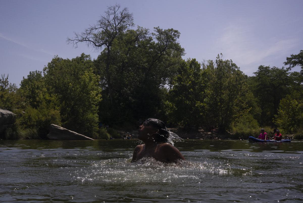 Pablo Zapato, 14, of Mission, shakes water off his head after jumping into the creek at Upper McKinney Falls at McKinney Falls State Park in Austin on July 29, 2023.